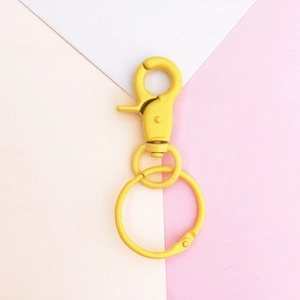 Close-up of matte yellow DIY lobster clasp with spring hook and large alloy metal ring