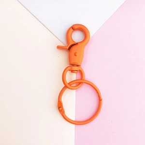 Close-up of orange matte lobster clasp with swivel ring for DIY keychain accessories