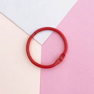 Detail of red painted metal lobster clasp and round ring for DIY keychain crafting