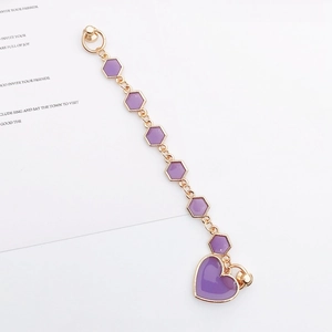 Detail of purple heart and hexagonal charm phone chain with gold metal edges