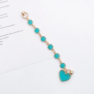 Detail of candy-colored DIY phone strap with gold metal heart charm and turquoise enamel