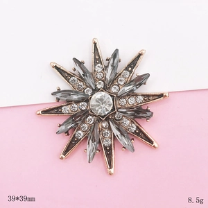 Detail view of a 39x39mm rose gold star brooch with grey marquise and white crystals
