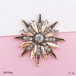 Vintage starburst brooch with crystals and gold metal, measures 39x39mm and weighs 8.5g