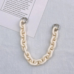 Close-up of cream acrylic chain strap with silver metal spring rings for DIY cases