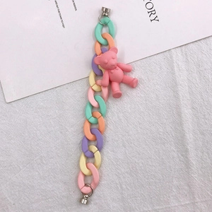 Close-up of a pastel macaron link chain with a pink 3D bear and silver metal clasps