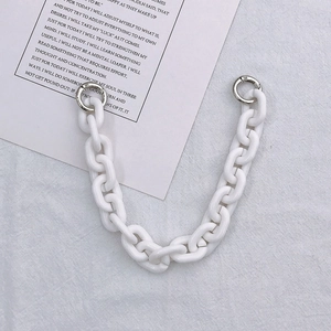 Acrylic white thick chain handle with silver spring buckles on grey fabric