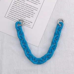 Close-up of bright blue acrylic chunky chain with silver spring buckles and decorative card