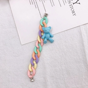 Detail of macaron resin chain with blue matte bear pendant and silver metal clasps