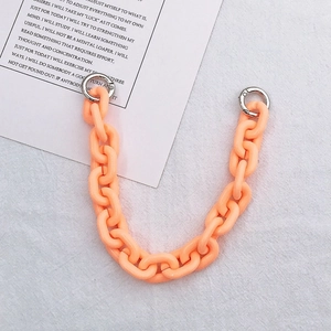 Macro shot of peach orange acrylic thick chain link strap with silver spring rings