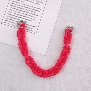 Close-up of DIY acrylic neon pink chain link with silver spring gate rings for bags