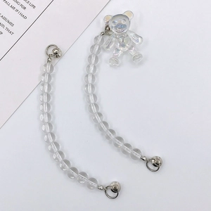 Detail of transparent beaded phone strap with iridescent 3D bear charm and silver clasp