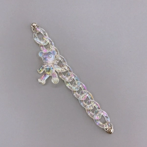 Detail showing acrylic colorful bear pendant and iridescent chain with metal clasps