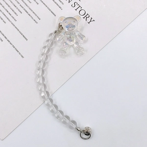 Detailed macro view of iridescent bear charm and transparent bead phone lanyard