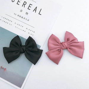 Handmade silk ribbon bow hair clips in black and dusty pink colors for DIY hair styling