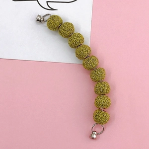 Macro view of olive green crochet bead strap with silver magnetic clasps for phone case