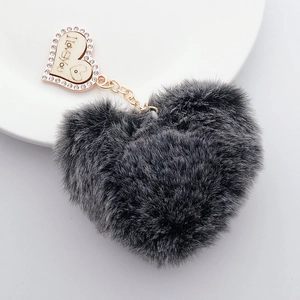 Detail of dark grey heart plush keychain with diamond-encrusted I Love You wood pendant