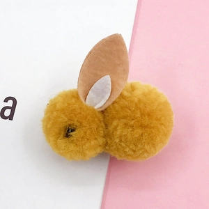 Detail of yellow plush rabbit charm with soft pom-pom texture and felt ears for DIY crafts