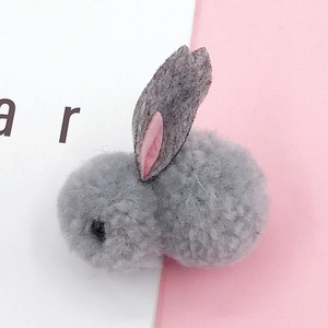 Detailed view of handmade grey plush rabbit accessory with felt ears for DIY crafts
