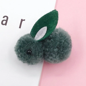 Detail view of cute dark green plush rabbit head accessories for DIY crafting