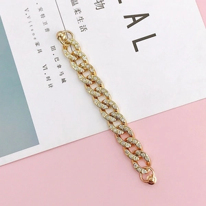 Goldene Cuban-Link-Kette für Handyhüllen mit Strasssteinen auf sanftem Pastell-Hintergrund