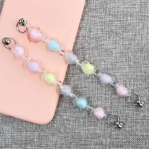 Detailed macro view of colorful acrylic heart-shaped beads on a DIY phone charm chain