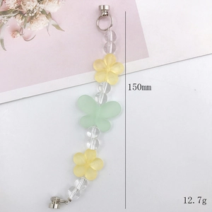 Bracciale fatto a mano in perle acriliche con fiori gialli e ciondoli a farfalla verde