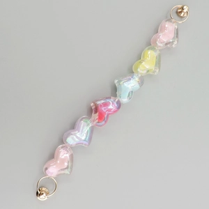 Detail of colorful acrylic heart beads chain with gold metal rings for DIY accessories