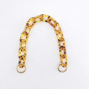 Detail of tortoise leopard acrylic chain link strap with gold round spring ring clips