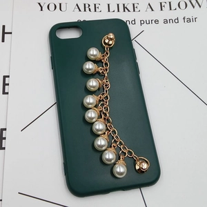 Detail of DIY phone case featuring dark green cover and golden chain with white pearls