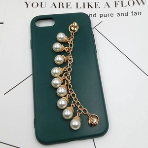 Detail of dark green matte phone case featuring a gold chain with white pearl charms
