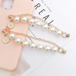 Elegant pearl phone charm strap with gold chain and white camellia flower pendant