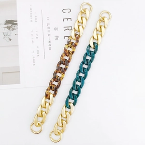Detail of tortoiseshell and marble acrylic chains with gold metal links and spring clasps