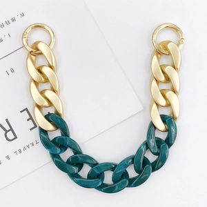 Detail of green marble acrylic and matte gold metal chain strap with spring rings