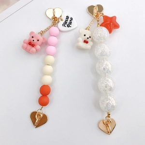 Detail of beaded keychain charms with flocked bear and acrylic crackle beads with heart clasp