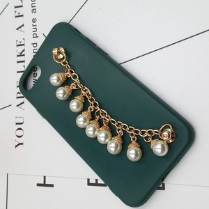 Dark green phone case with golden chain and nine white pearls on white background