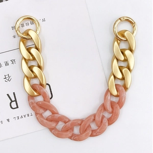 Close-up of matte gold metal links and pink marble acrylic chain with spring ring clasps