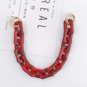 Detail of red marble texture resin chain link with golden spring ring for bags