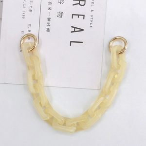 Detailed view of cream acrylic chunky chain link with gold metal ring clasp for DIY handbags