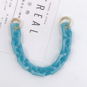 Detail of sky blue marble acrylic chain strap with gold metal rings for handbags