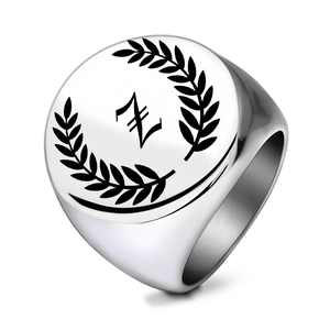 Macro detail of silver stainless steel signet ring with gothic letter Z and laurel wreath