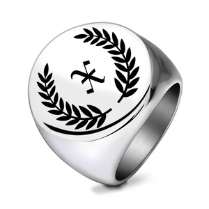 Macro detail of silver stainless steel signet ring with laurel wreath and engraved X