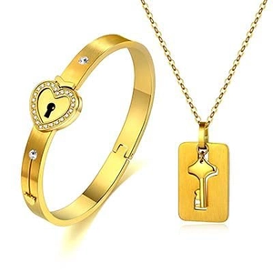 Detail of gold heart lock bracelet and key pendant necklace set with crystal accents