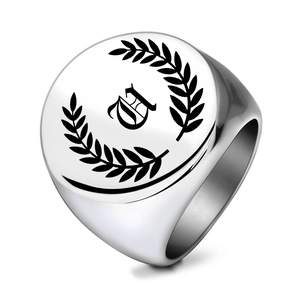 Detail of laser engraved laurel wreath and gothic letter A on silver stainless steel ring