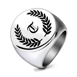 Close-up of a men's silver signet ring with gothic letter E and laurel wreath engraving