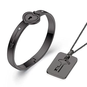 Detail of black matte stainless steel couple jewelry set with heart lock and key pendant