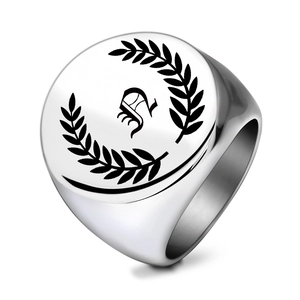 Macro detail of silver stainless steel signet ring with gothic letter S and laurel wreath