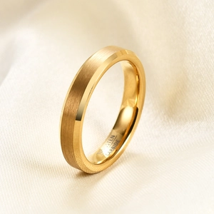 Macro shot of 18K gold tungsten carbide ring with brushed finish and inner engraving