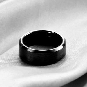 Minimalist black stainless steel ring with brushed surface and polished beveled edges