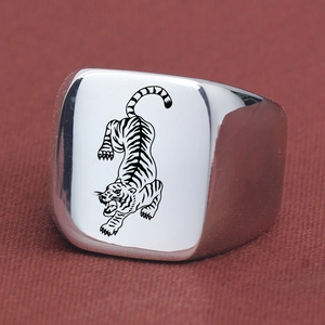 Macro shot of 18mm punk tiger signet ring in polished stainless steel with laser engraving