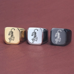 Detailed view of square punk tiger rings in gold, silver, and black stainless steel